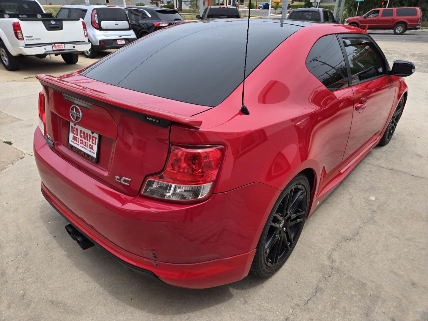 2013 Red Scion tC Sports Coupe 6-Spd AT (JTKJF5C74D3) with an 2.4L L4 DOHC 16V engine, Manual Transmission transmission, located at 503 West Court, Seguin, TX, 78155, (830) 379-3373, 29.568621, -97.969803 - Photo#2