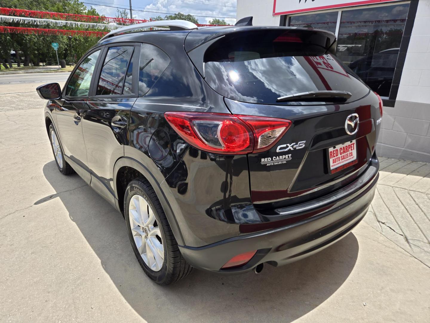 2013 Black Mazda CX-5 Grand Touring (JM3KE2DE9D0) with an 2.0L I4 F DOHC 16V engine, 6-Speed Automatic transmission, located at 503 West Court, Seguin, TX, 78155, (830) 379-3373, 29.568621, -97.969803 - 2013 Mazda CX-5 Grand Touring with a 2.0L I4 F DOHC 16V, Automatic, Tilt, Cruise, AM/FM/CD Touchscreen Stereo, Power Windows, Locks, Seat and Side Mirrors, Bluetooth, Leather Seating, Power Sunroof, Dual Climate Control, Heated Seats, Navigation System, Alloy Wheels, Backup Camera, Rear Wiper, Rear - Photo#3