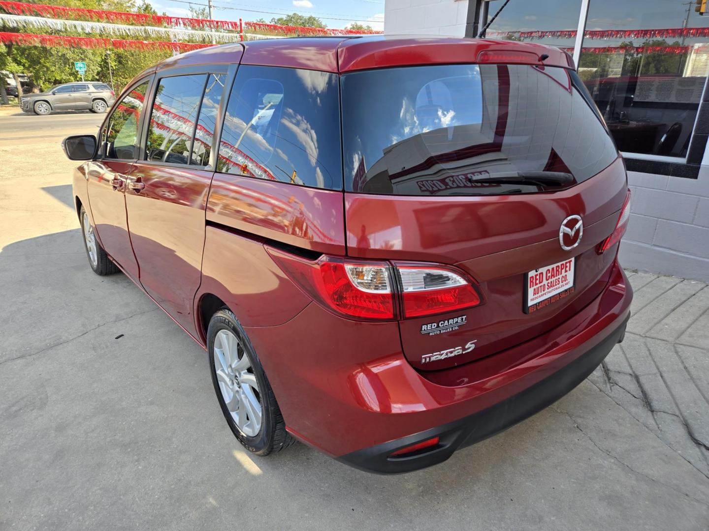 2014 Red Mazda MAZDA5 Sport AT (JM1CW2BL2E0) with an 2.5L L4 DOHC 16V engine, 5-Speed Automatic transmission, located at 503 West Court, Seguin, TX, 78155, (830) 379-3373, 29.568621, -97.969803 - 2014 Mazda MAZDA5 Sport with a 2.5L L4 DOHC 16V, Automatic, Tilt, Cruise, AM/FM/CD Stereo, Power Windows, Locks and Side Mirrors, Third Row Seating, Foldable Rear Center Console, Alloy Wheels, Tinted Windows, Rear Wiper, Rear Defroster and more!! - Photo#3