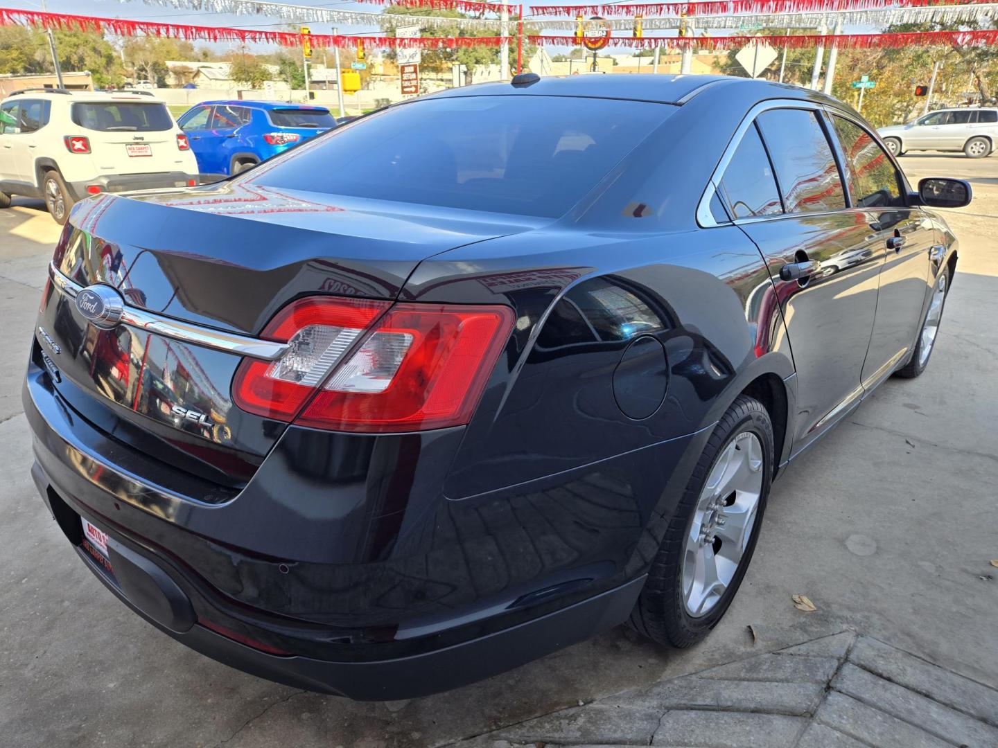 2011 Black Ford Taurus SEL FWD (1FAHP2EWXBG) with an 3.5L V6 DOHC 24V engine, 6-Speed Automatic transmission, located at 503 West Court, Seguin, TX, 78155, (830) 379-3373, 29.568621, -97.969803 - 2011 Ford Taurus SEL FWD with a 3.5L V6 DOHC 24V, Automatic, Tilt, Cruise, AM/FM/CD Stereo, Power Windows, Locks, Seat and Side Mirrors, Bluetooth, Leather Seating, Heated Seats, Tinted Windows, Dual Climate Control, Alloy Wheels, Rear Defroster and more!! - Photo#2