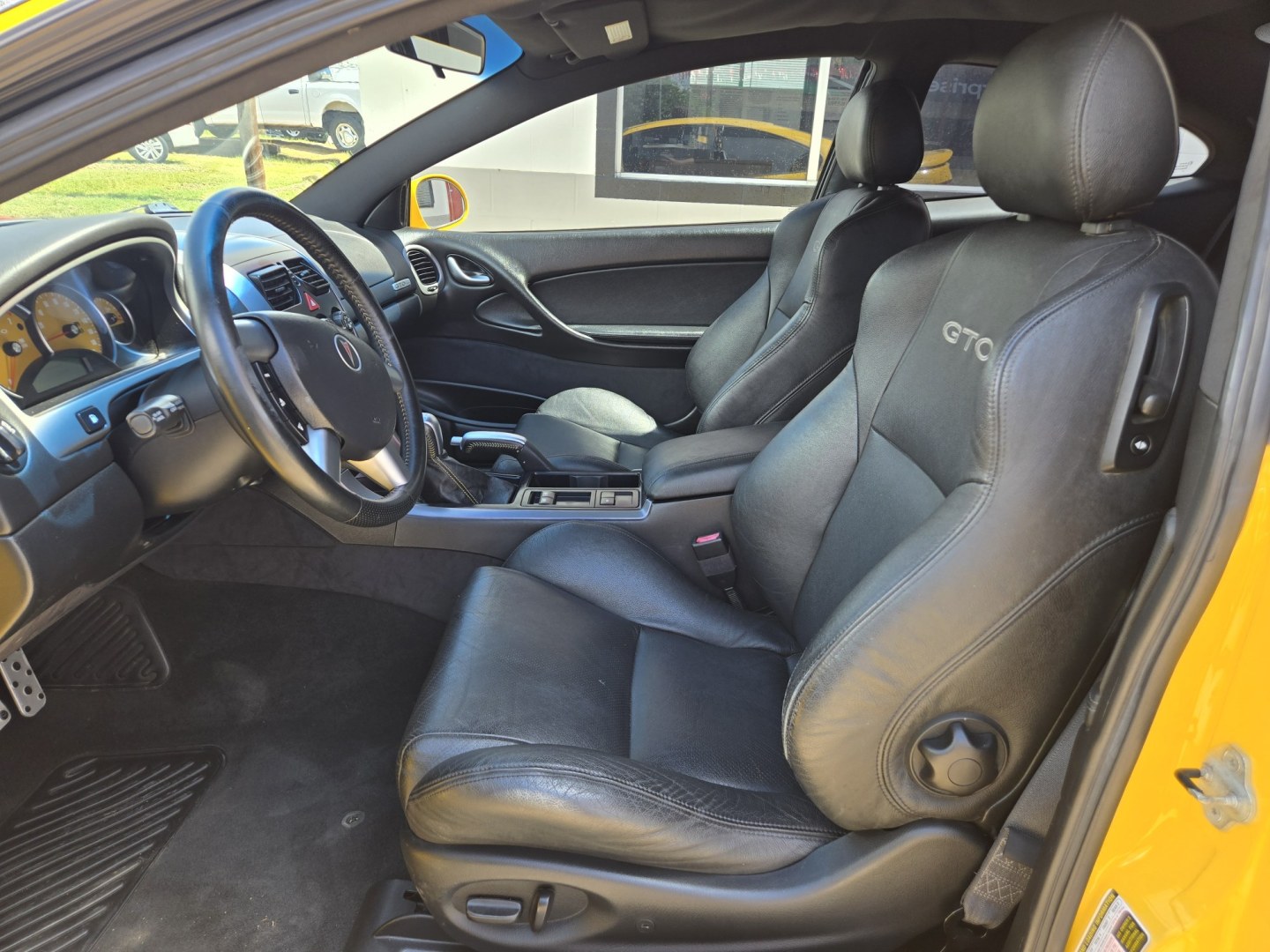 2004 YELLOW Pontiac GTO Coupe (6G2VX12GX4L) with an 5.7L V8 OHV 16V engine, Manual Transmission transmission, located at 503 West Court, Seguin, TX, 78155, (830) 379-3373, 29.568621, -97.969803 - 2004 Pontiac GTO Coupe with a 5.7L V8 OHV 16V, Standard Transmission, Tilt, AM/FM/6 Disc CD Stereo System, Power Windows, Locks and Seat, Leather Seating, Automatic Headlights, Rear Defroster and more!! - Photo#4